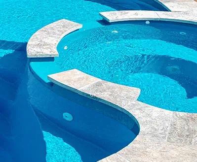 A Leisure Pools fiberglass pool in Crystal Blue color
