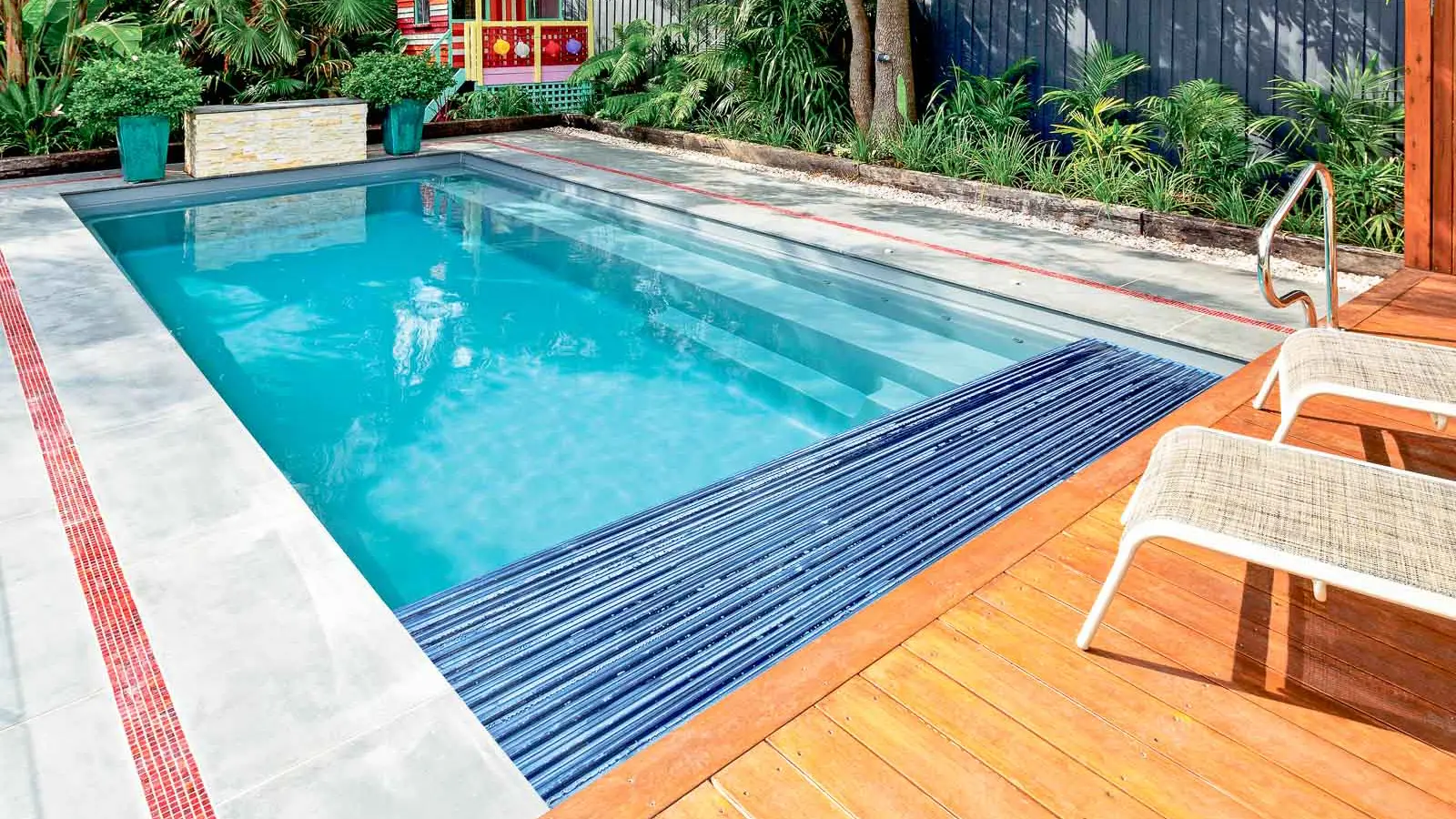 The Reflection with Cover, a fiberglass pool with full-length bench seating and built-in cover box